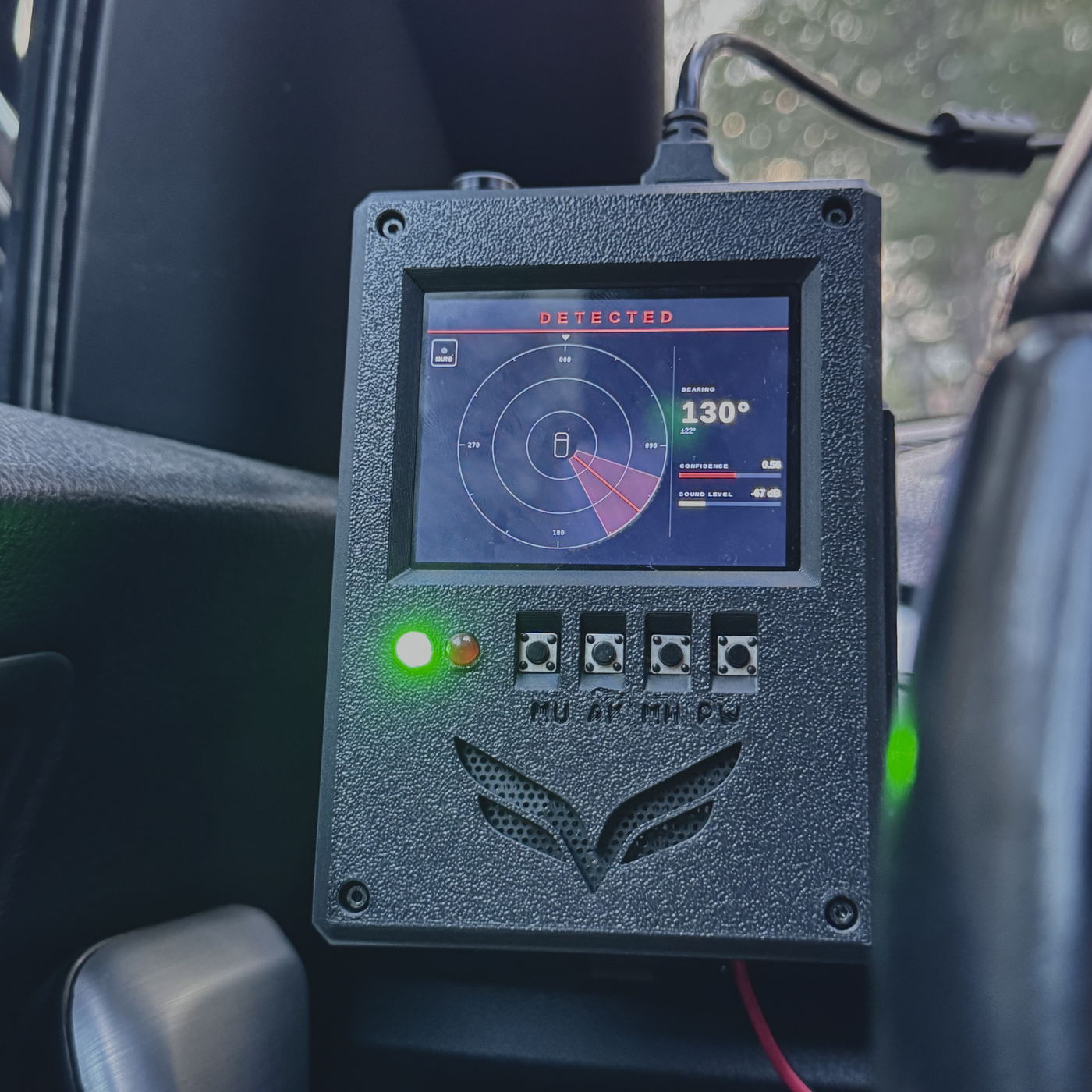 The Falcon driver-facing display mounted inside a vehicle, showing DETECTED, a bearing of 130 degrees with a confidence bar, and a highlighted sector on a compass rose.