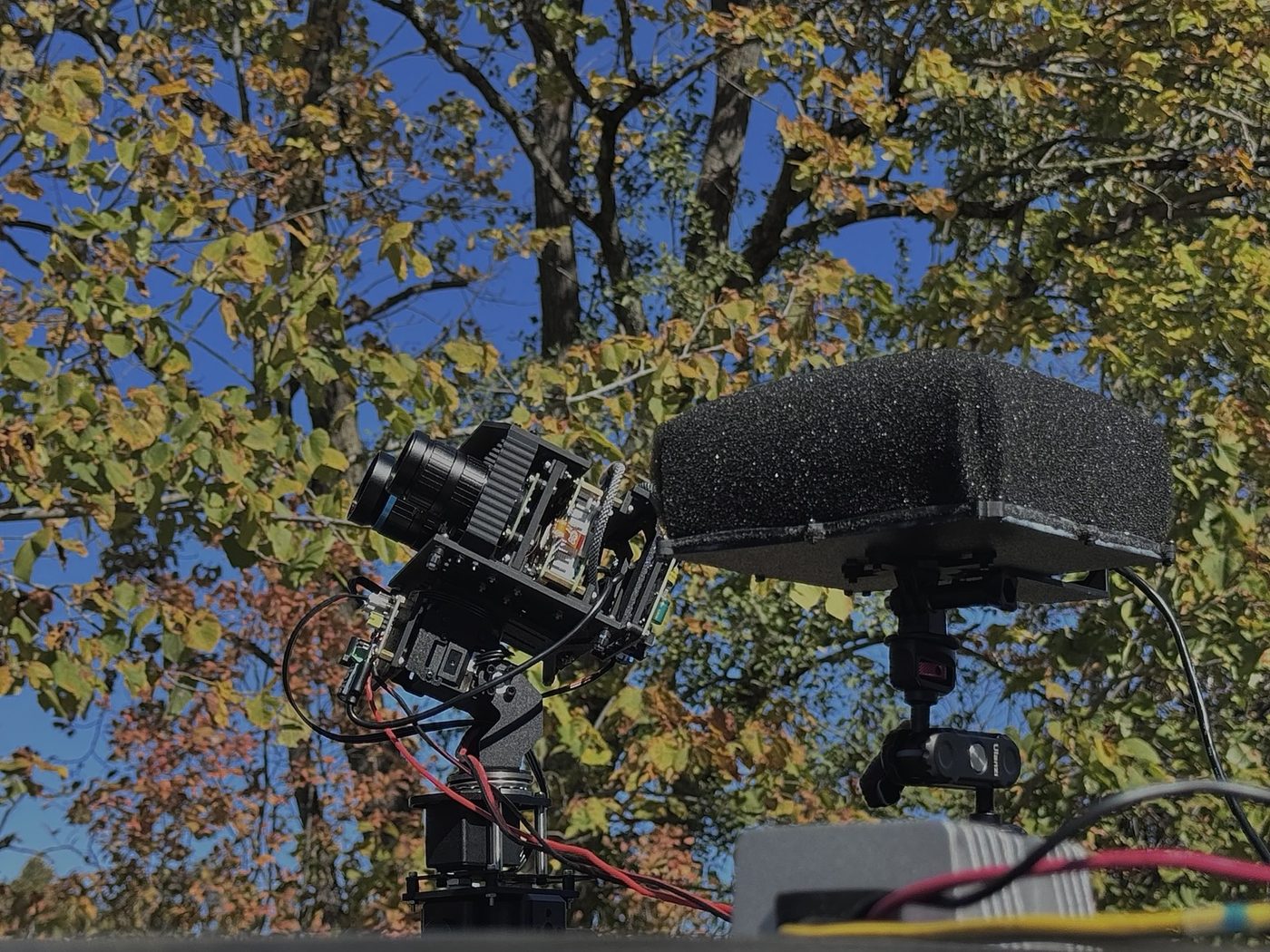 The GW-VSR1 visual module, two cameras on a pan-tilt head, beside the acoustic array on a vehicle roof